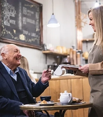 A man paying by card at a restaurant